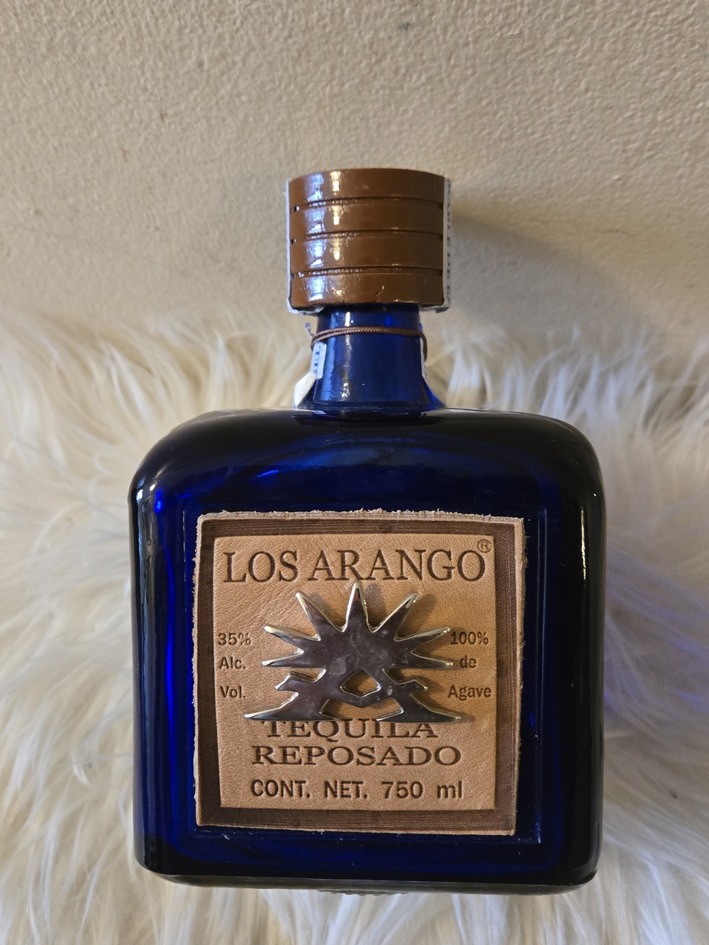 Empty Blue Glass Los Arango Tequila Reposado Bottle